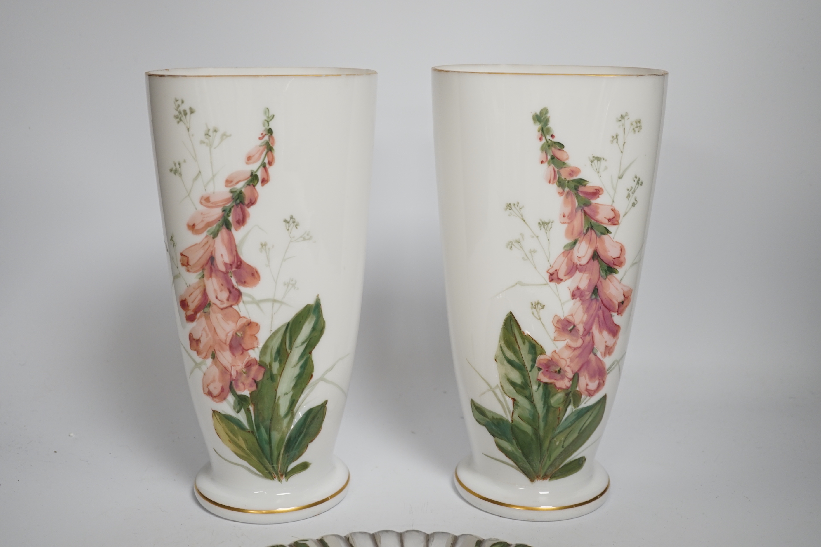 A pair of French opaque white glass vases enamelled with foxgloves, a plated bread board and a plated nutcracker, vases 25cm high